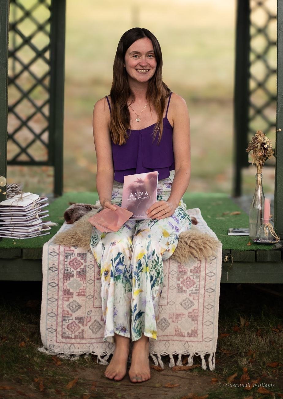 Rachael Ball smiling, holding her book.